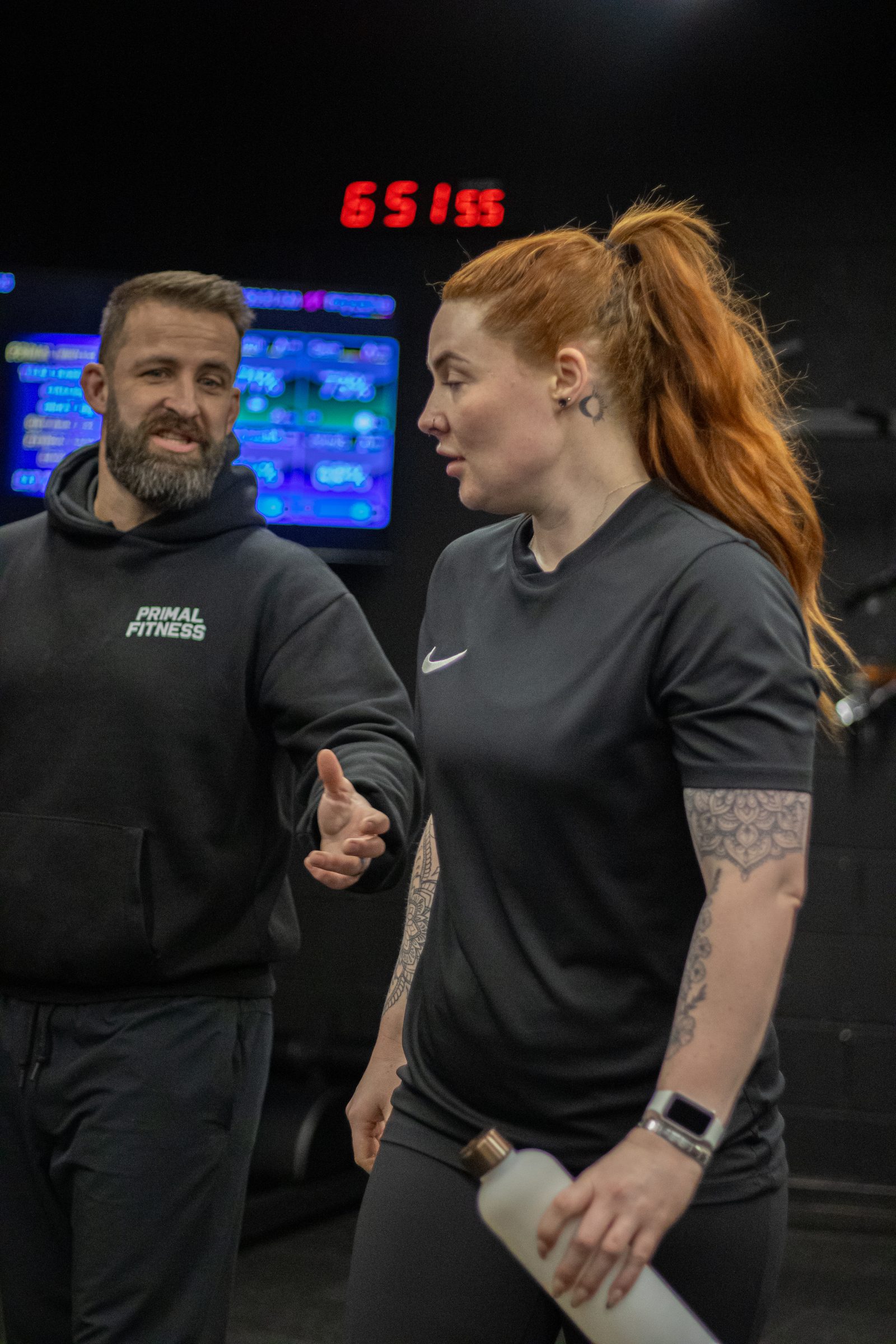 A Primal coach talking with a member by the timer