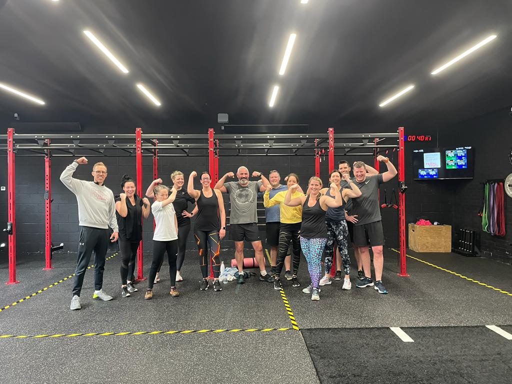 Primal members flexing in front of the red rigs